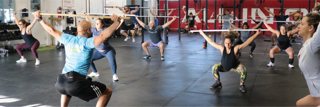 A CrossFit class doing a warm up together